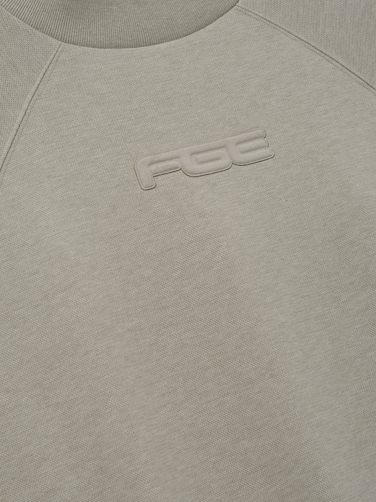 Fear of God Essentials Pique 90s Relaxed Mockneck Raglan LS Tee Pyrite Heather - Im Your Wardrobe