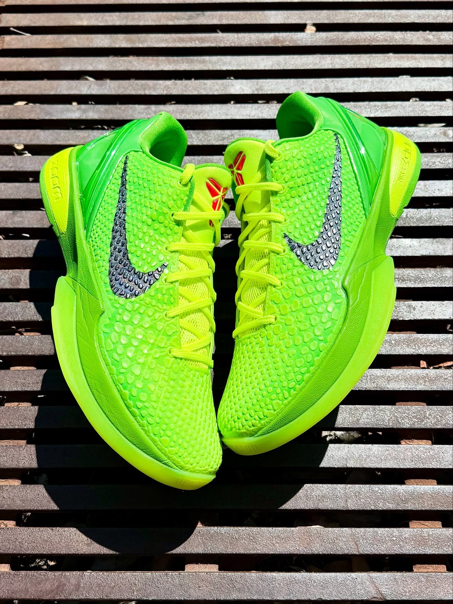 Nike Kobe 6 Protro 'Grinch' on a metal grate (photo: @untdkicks via Pinterest)