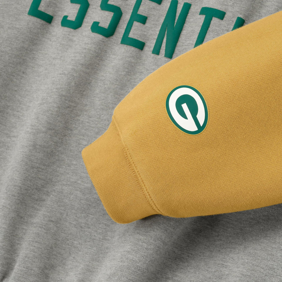 Fear of God Essentials Packers Sport Hoodie Concrete Heather/Canyon - Im Your Wardrobe